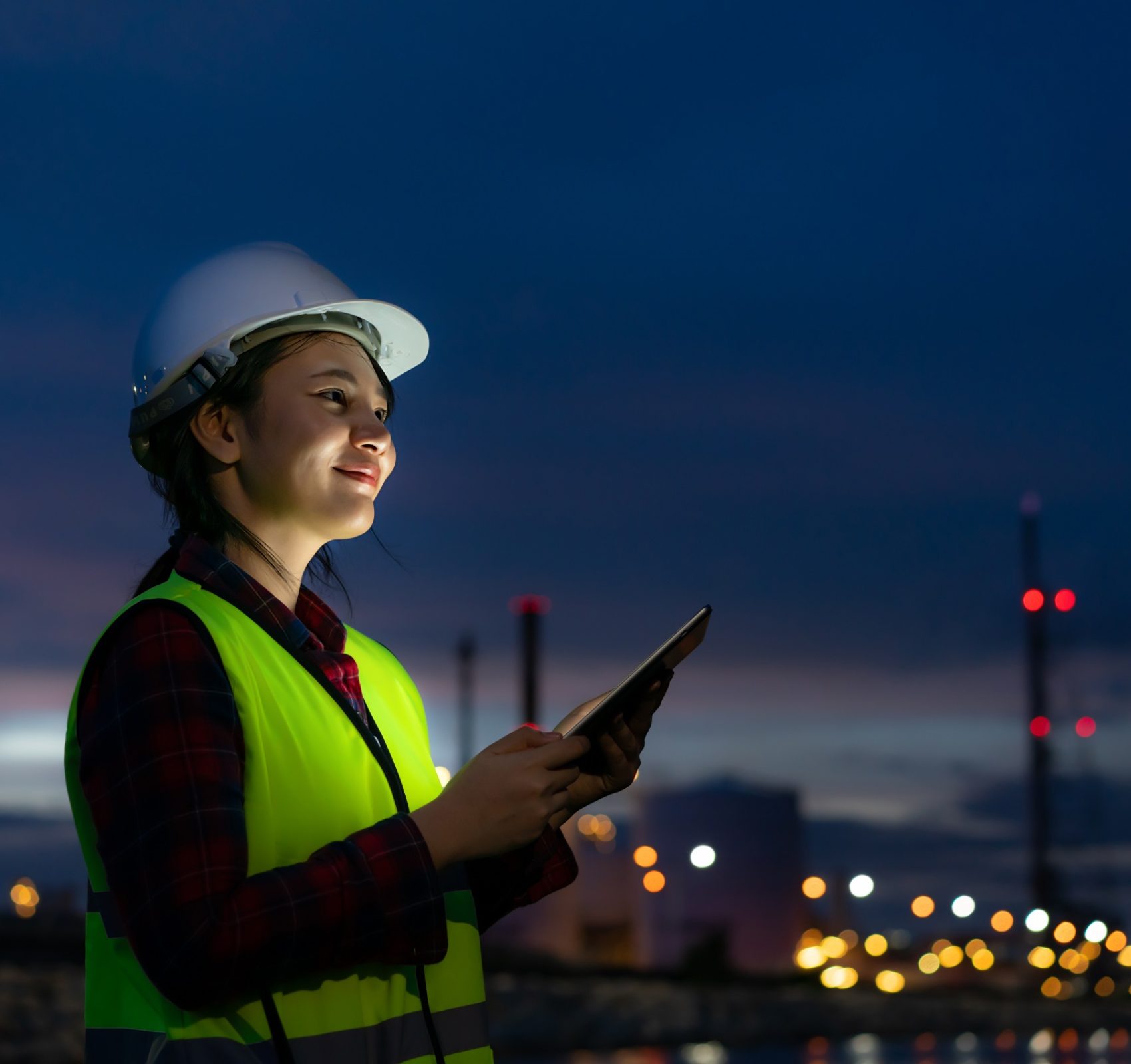 Asian,Woman,Petrochemical,Engineer,Working,At,Night,With,Digital,Tablet